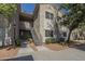 Attractive condo building exterior with well-manicured landscaping and convenient stairway access to upper floors at 3830 E Lakewood Pkwy # 1051, Phoenix, AZ 85048