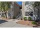 Inviting condo exterior featuring well-maintained landscaping and convenient stairway access to upper units at 3830 E Lakewood Pkwy # 1051, Phoenix, AZ 85048