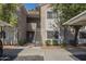 Inviting condo complex with well-maintained landscaping, covered parking, and staircase access to upper units at 3830 E Lakewood Pkwy # 1051, Phoenix, AZ 85048