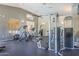 A spacious gym with a variety of weight machines and cardio equipment on a black rubber floor at 3830 E Lakewood Pkwy # 1051, Phoenix, AZ 85048