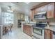 Bright kitchen adjacent to a dining area, features stainless steel appliances and a view of the living space at 3830 E Lakewood Pkwy # 1051, Phoenix, AZ 85048