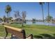 Serene lakeside park offers a bench with views of tranquil water and lush landscaping at 3830 E Lakewood Pkwy # 1051, Phoenix, AZ 85048
