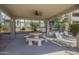 Covered outdoor seating area featuring a picnic table and lounge chairs, ideal for relaxing by the pool at 3830 E Lakewood Pkwy # 1051, Phoenix, AZ 85048