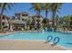 Community pool offers clear blue water, mature palms and landscaping at 3830 E Lakewood Pkwy # 1051, Phoenix, AZ 85048
