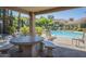 A covered patio area at the community pool with stone table and chairs offers a shady spot at 3830 E Lakewood Pkwy # 1051, Phoenix, AZ 85048
