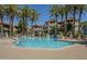 Community pool offers clear blue water, mature palms and landscaping at 3830 E Lakewood Pkwy # 1051, Phoenix, AZ 85048