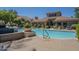 Inviting community pool with clear blue water, landscaping, and comfortable lounge chairs at 3830 E Lakewood Pkwy # 1051, Phoenix, AZ 85048