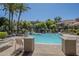 Beautiful community pool with palm trees and lounge chairs, perfect for relaxation and recreation at 3830 E Lakewood Pkwy # 1051, Phoenix, AZ 85048