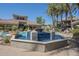 Community pool with decorative fountain, lounge chairs and lush landscaping at 3830 E Lakewood Pkwy # 1051, Phoenix, AZ 85048