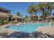 Community pool with lounge chairs, mature landscaping, and clear blue water at 3830 E Lakewood Pkwy # 1051, Phoenix, AZ 85048