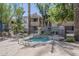 Community spa offering relaxation with metal railing and seating surrounded by lush landscaping at 3830 E Lakewood Pkwy # 1051, Phoenix, AZ 85048