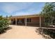 Exterior showing covered patio overlooking sand backyard with foliage and blue skies above at 3833 W Rene Dr, Chandler, AZ 85226