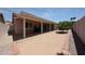 View of the backyard featuring a covered patio and desert landscaping with rock features at 3833 W Rene Dr, Chandler, AZ 85226