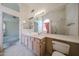 Large bathroom features dual sinks, shower, large mirror, and access to another room at 3833 W Rene Dr, Chandler, AZ 85226