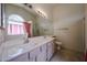 Well-lit bathroom with a double sink vanity and shower at 3833 W Rene Dr, Chandler, AZ 85226