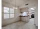 Bright kitchen with tile floors, ample storage, and a charming light fixture at 3833 W Rene Dr, Chandler, AZ 85226