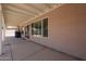 View of the covered patio with beige stucco walls and a glimpse of the yard at 3833 W Rene Dr, Chandler, AZ 85226