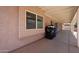 Covered patio showing stucco wall, and adjacent trash and recycle cans at 3833 W Rene Dr, Chandler, AZ 85226