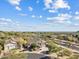 An aerial view of a beautiful home in a well-landscaped desert community under a blue sky at 4111 N Starry Pass Cir, Mesa, AZ 85207