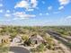 Overhead shot of a home in a desert community with blue sky and some cloud coverage at 4111 N Starry Pass Cir, Mesa, AZ 85207
