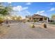 Backyard with desert landscaping, spiral staircase to the roof deck and covered patio with seating area at 4111 N Starry Pass Cir, Mesa, AZ 85207