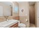 Bathroom with a white sink and faucet, wooden cabinets, tile accents, and decorative lighting at 4111 N Starry Pass Cir, Mesa, AZ 85207