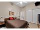 Bedroom with neutral paint, tiled floors, a closet, and a comfortable bed, with an entrance to the bathroom at 4111 N Starry Pass Cir, Mesa, AZ 85207