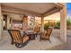 Spacious covered patio with brick accents, a seating area, and a spiral staircase at 4111 N Starry Pass Cir, Mesa, AZ 85207