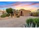 Charming home featuring desert landscaping, beautiful desert trees, and a two-car garage at 4111 N Starry Pass Cir, Mesa, AZ 85207