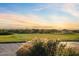 Beautiful view of a golf course and mountain scenery at sunset at 4111 N Starry Pass Cir, Mesa, AZ 85207