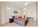 Bedroom with neutral paint, tiled floors, and a comfortable bed, with an entrance to the bathroom at 4111 N Starry Pass Cir, Mesa, AZ 85207