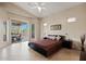 Bedroom with neutral paint, tiled floors, a sliding glass door to the outside, and a comfortable bed at 4111 N Starry Pass Cir, Mesa, AZ 85207