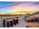 Roof deck with outdoor seating and views of the surrounding mountains at sunset at 4111 N Starry Pass Cir, Mesa, AZ 85207