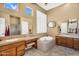 Bright bathroom with double sinks, soaking tub, shower, and natural light at 41908 N Harbour Town Ct, Anthem, AZ 85086