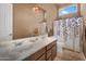 Bathroom features double sinks, tiled floors, shower and bathtub, and decorative lighting fixtures at 41908 N Harbour Town Ct, Anthem, AZ 85086
