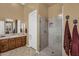 Modern bathroom featuring walk in shower, single sink vanity, and decorative tile flooring at 41908 N Harbour Town Ct, Anthem, AZ 85086