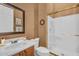 Traditional bathroom features shower, single sink vanity, and decorative mirror at 41908 N Harbour Town Ct, Anthem, AZ 85086