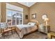 Cozy bedroom with plush carpet, ceiling fan, plantation shutters, and natural lighting at 41908 N Harbour Town Ct, Anthem, AZ 85086
