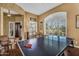 Inviting bonus room with wood flooring, a ping pong table, plantation shutters and view to the front yard at 41908 N Harbour Town Ct, Anthem, AZ 85086