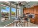 Bright breakfast nook features pool view, tile floors, and built in cabinets with natural stone backsplash at 41908 N Harbour Town Ct, Anthem, AZ 85086