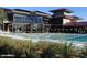 Clubhouse pool area with expansive windows, comfortable lounge chairs, and lush landscaping, offering a resort-like feel at 41908 N Harbour Town Ct, Anthem, AZ 85086