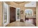Elegant foyer with tile flooring, a decorative clock, and large windows with plantation shutters at 41908 N Harbour Town Ct, Anthem, AZ 85086