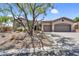 Charming home features a desert landscape, a private drive and a spacious 3-car garage at 41908 N Harbour Town Ct, Anthem, AZ 85086