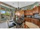 Open floor plan kitchen with custom tile and granite countertops with stainless steel appliances and natural lighting at 41908 N Harbour Town Ct, Anthem, AZ 85086