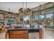 Open kitchen overlooking living area featuring custom tile, granite countertops, and stainless steel appliances at 41908 N Harbour Town Ct, Anthem, AZ 85086