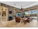 Beautiful living room with stone accent wall, fireplace, tile flooring and access to the backyard at 41908 N Harbour Town Ct, Anthem, AZ 85086