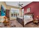 Spacious main bedroom with plush carpet, ceiling fan, and private backyard pool access at 41908 N Harbour Town Ct, Anthem, AZ 85086