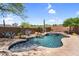 Backyard pool with rock waterfall and desert landscaping, offering a tranquil retreat at 41908 N Harbour Town Ct, Anthem, AZ 85086