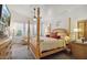 Luxurious main bedroom with four-poster bed, soft lighting, and ample natural light at 4223 E Wildcat Dr, Cave Creek, AZ 85331