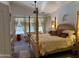 Spacious main bedroom featuring a four poster bed, plush carpet, and large windows for natural light at 4223 E Wildcat Dr, Cave Creek, AZ 85331